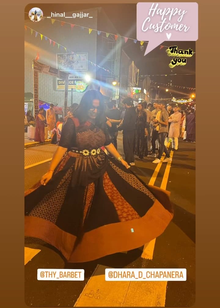 a woman in a dress dancing on a street